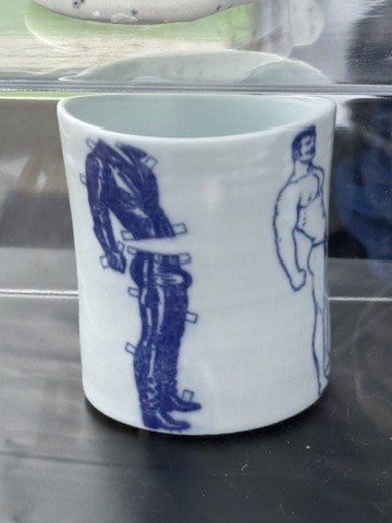 Porcelain cup with cobalt figure illustrations