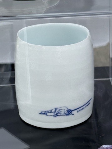 Porcelain cup with a cobalt “Loose Ends” illustration